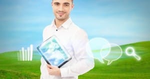 Man using his tablet computer outdoor at countryside. Mobile tec